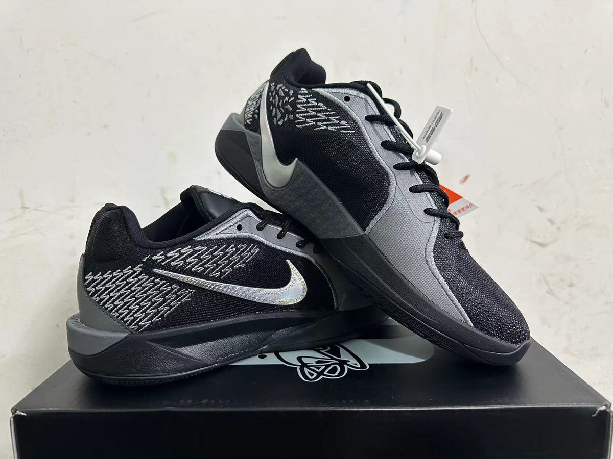 Pair of black and grey Nike Kobe basketball shoes displayed together