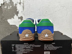 Rear view of blue Converse shoes with green heel panels, white star heel details, and gum-colored soles