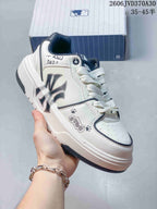Angled side view highlighting the large side graphic, white upper, and chunky sole.