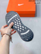 Close-up of the black textured outsole showing segmented traction pods and white cushioning openings.