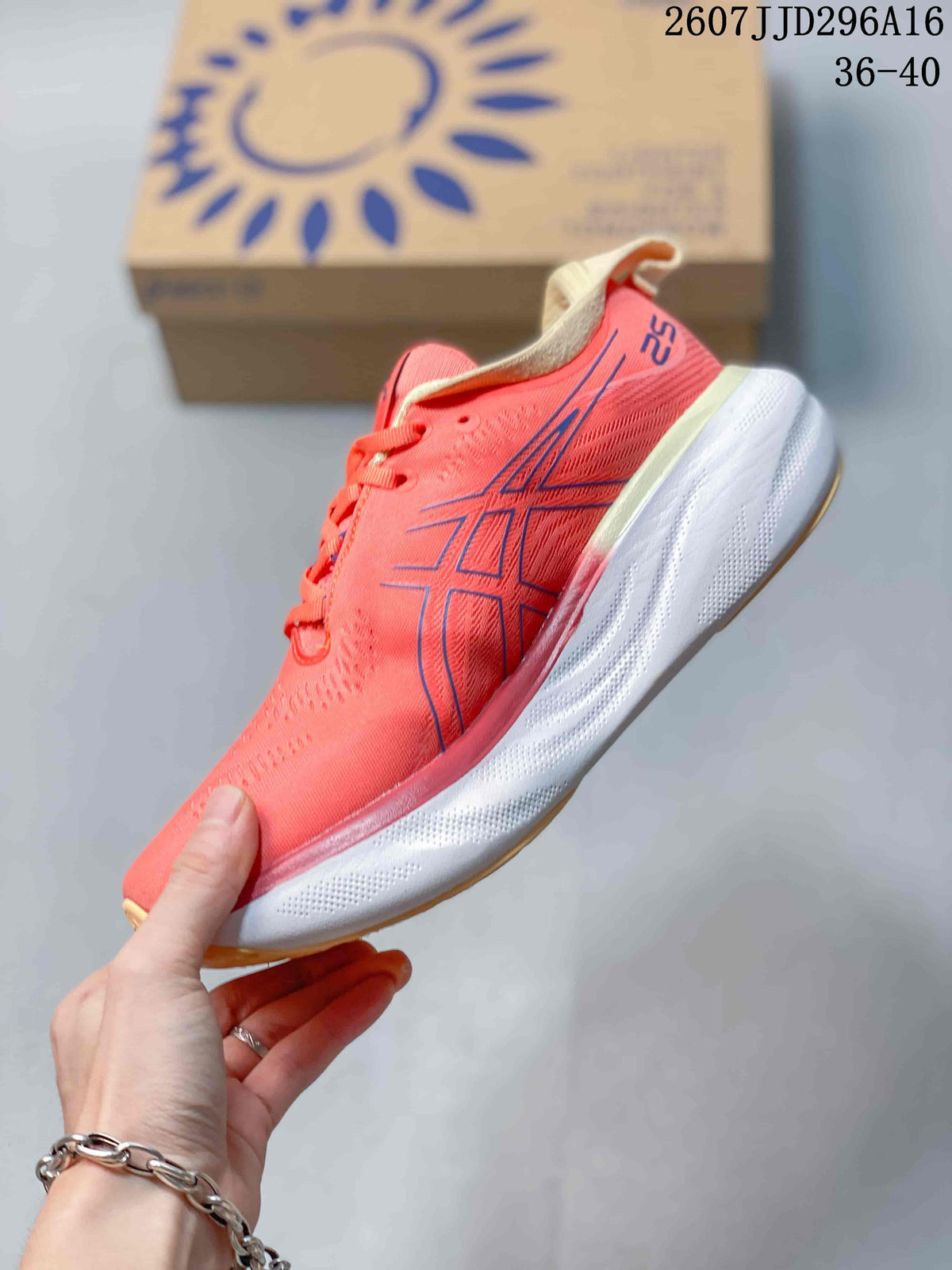 Side profile of the coral pink ASICS running shoe showing dark blue branding, cream heel detail and a thick white midsole.