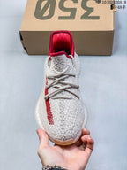 Front view showing the knit toe, laces, and red collar lining.