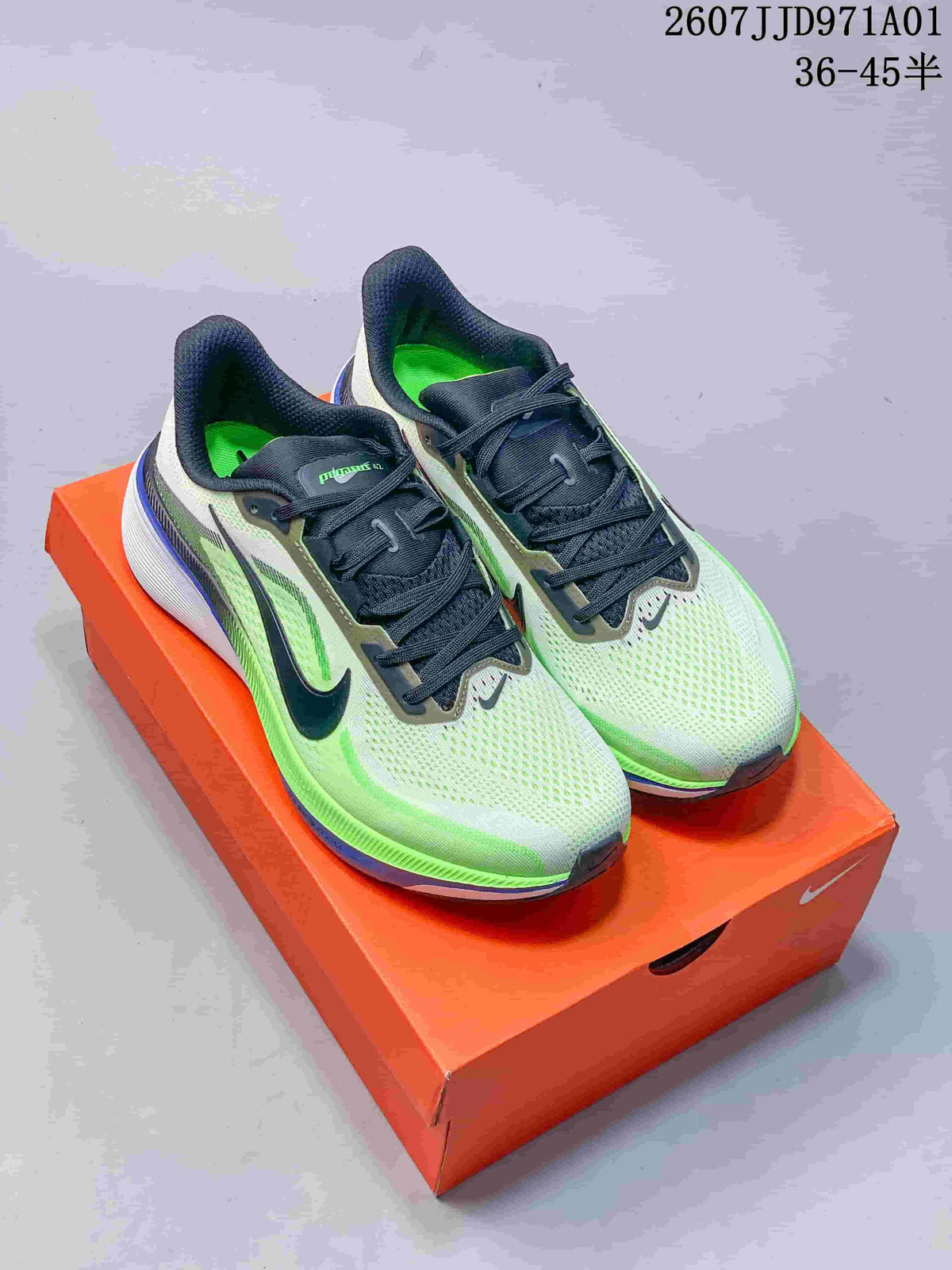 Pair of light grey and neon green Nike Pegasus 42 running shoes on an orange shoe box