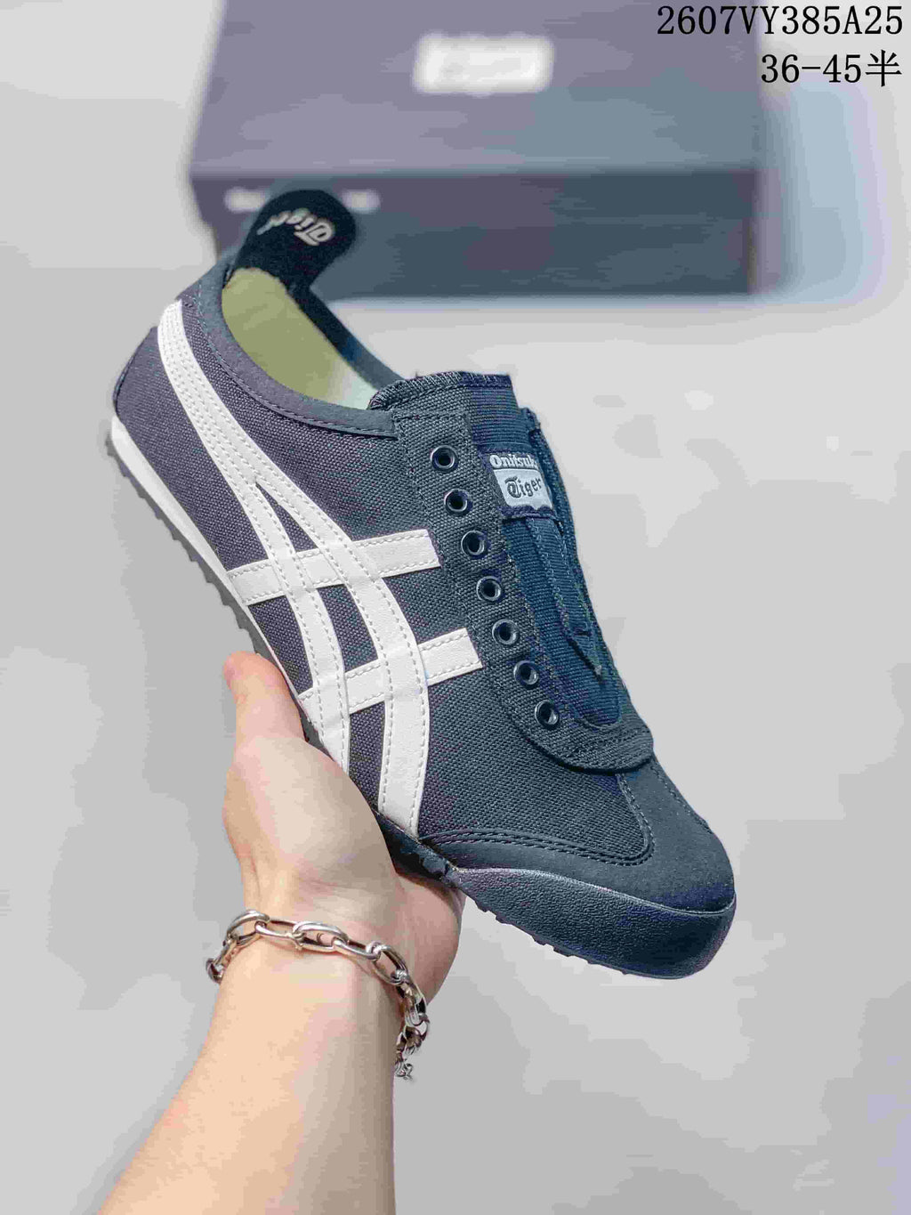 Dark navy Onitsuka Tiger slip-on sneaker with contrasting white side stripes.