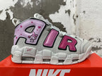 Side view of Nike sneakers with oversized AIR lettering, a rabbit graphic, and pink and lavender accents.