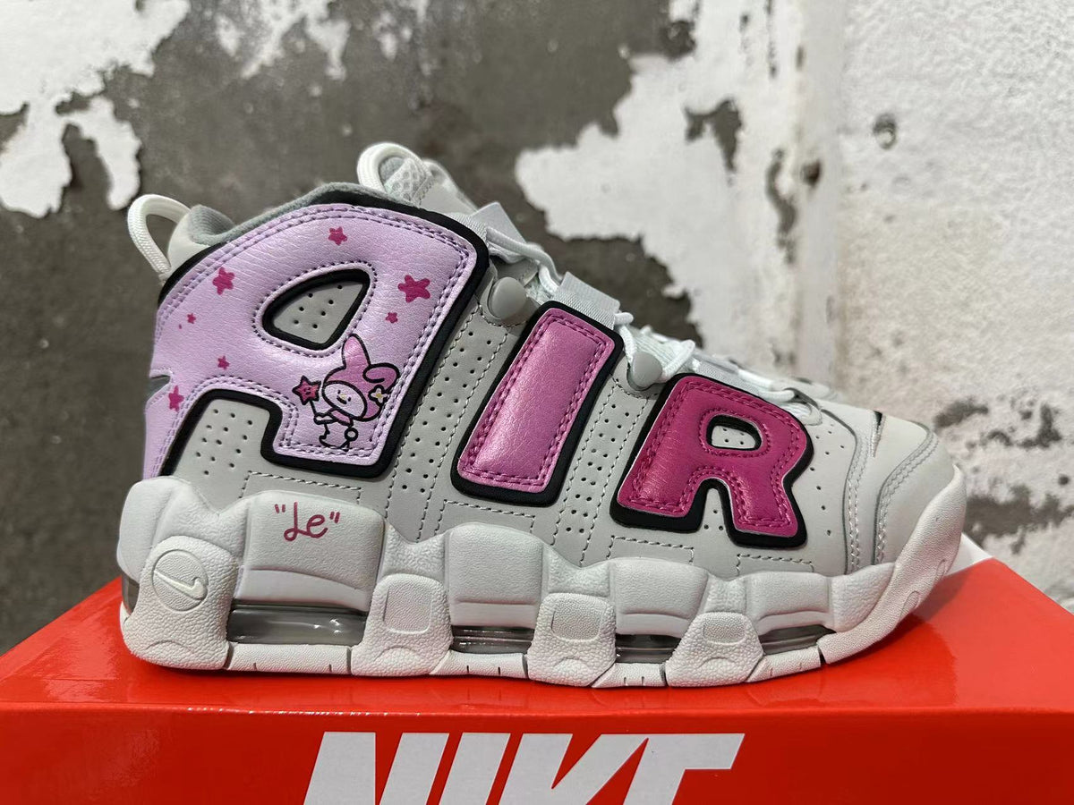 Side view of Nike sneakers with oversized AIR lettering, a rabbit graphic, and pink and lavender accents.