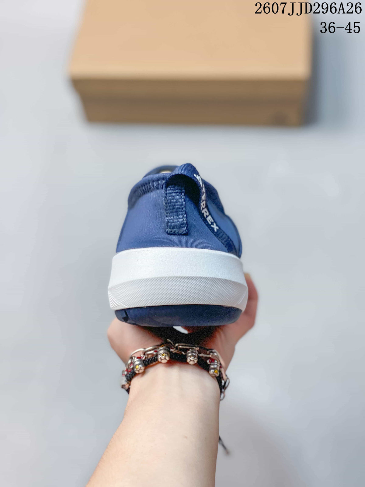 Rear view of the navy slip-on shoe showing the heel pull tab and white midsole.