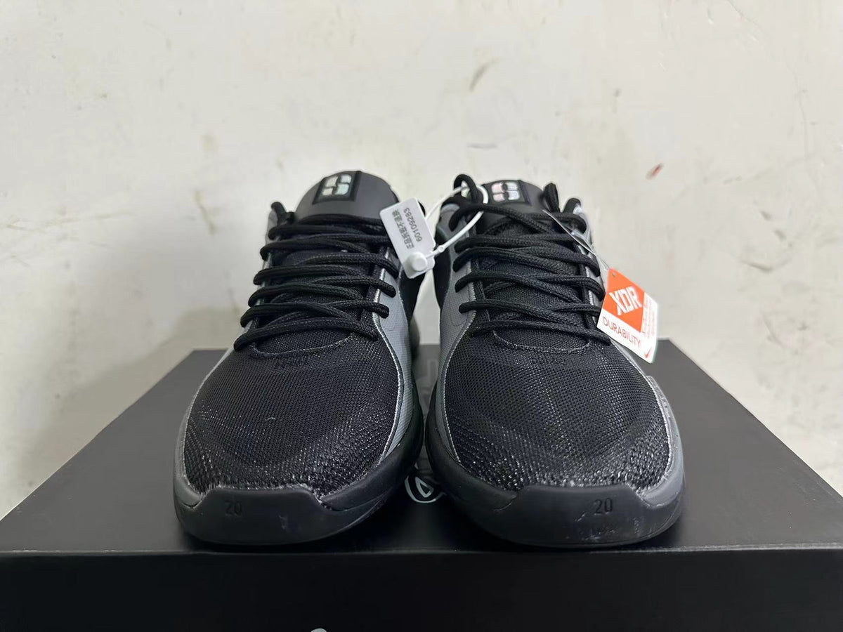 Front view showing black uppers, grey trim, and lace-up closures