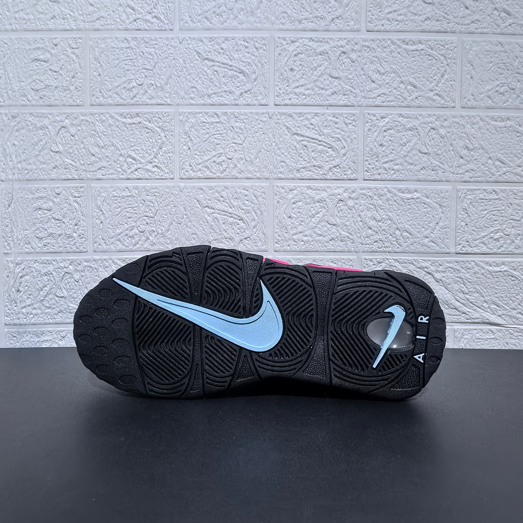 Outsole view of a black Nike sneaker with a light-colored swoosh