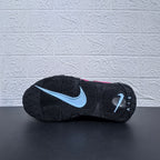 Outsole view of a black Nike sneaker with a light-colored swoosh