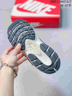 Underside of the sneaker showing a segmented black-and-white rubber outsole with textured tread.