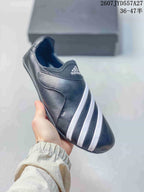 Angled view showing the black slip-on upper, padded collar, and white stripe detailing