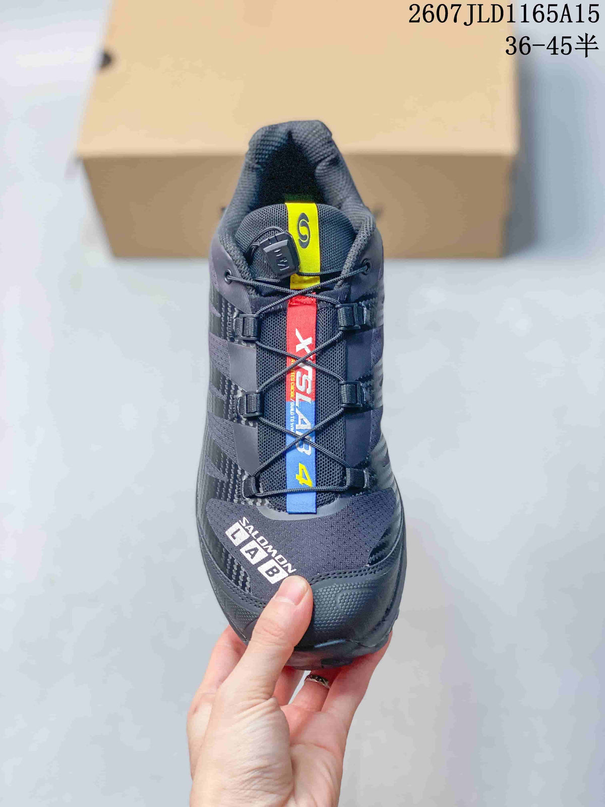 Top view of the black sneaker showing the tongue, lace-toggle system, multicolor lace panel, and Salomon branding.