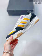Side profile of the adidas Tekkira Cup sneaker showing the layered upper, yellow side stripes, white midsole and gum outsole.