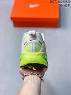 Rear view showing the white heel, neon green midsole, pull tab and black outsole.