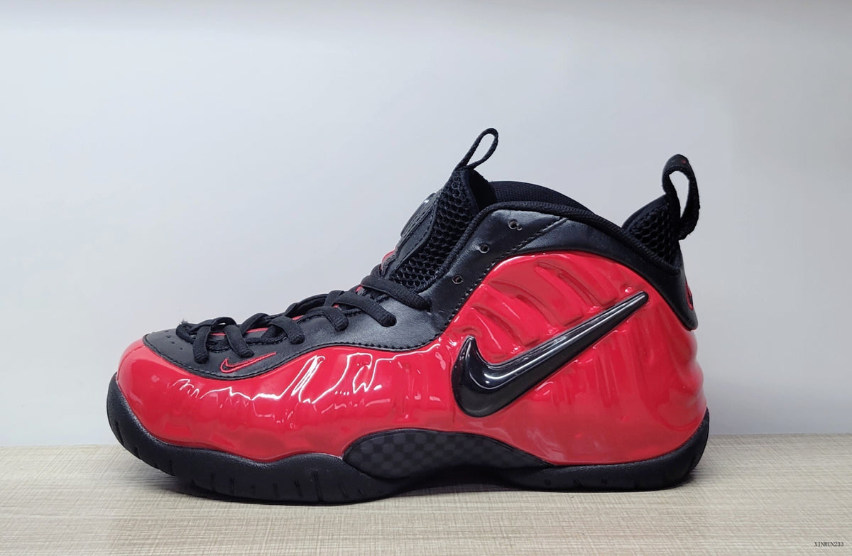 Side view highlighting the glossy red panels and black Swoosh