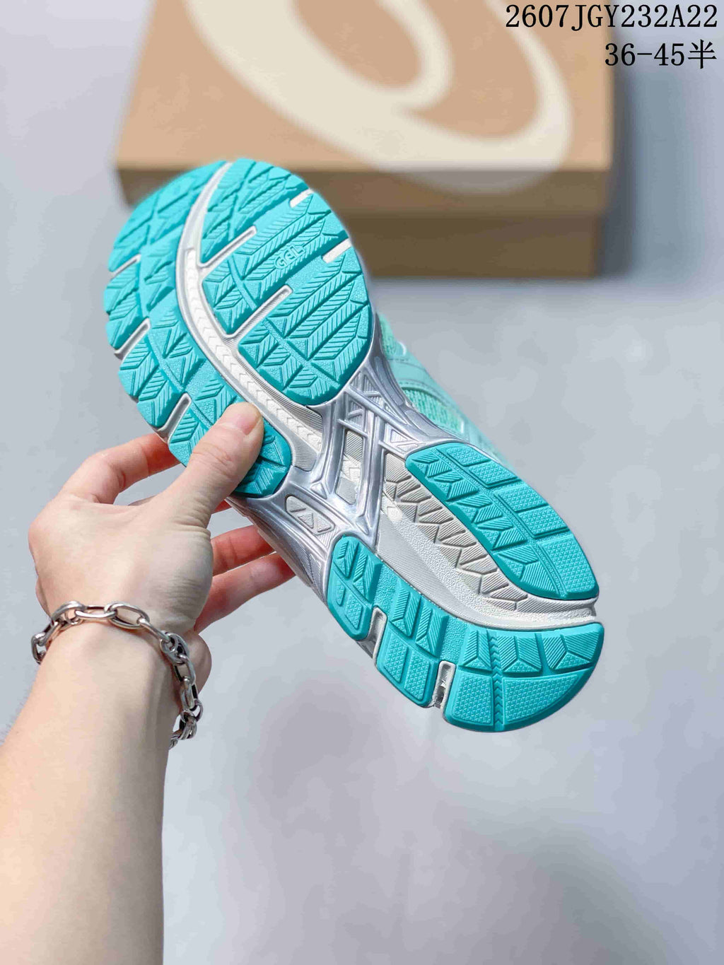 Outsole view showing the teal and white patterned tread of the sneaker.