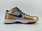 Side view of the sneaker showing its striped panel, gold overlays, and patterned outsole.