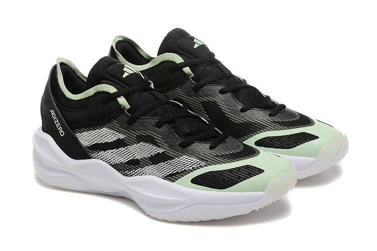Pair of black Adidas Adizero shoes with mint accents, shown at an angle