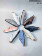 Several closed-toe, open-back sandals arranged in a circle, shown in assorted colors.