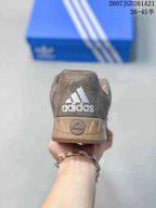 Rear view of the sneaker showing Adidas heel embroidery and the gum-colored heel section.