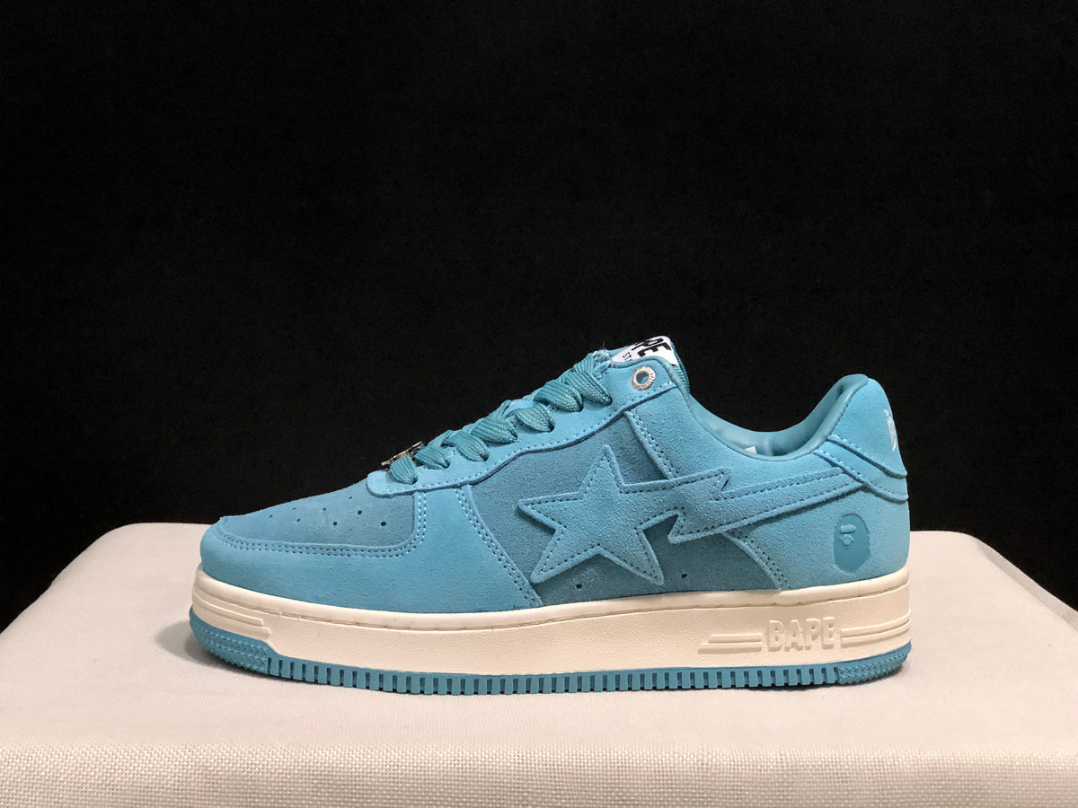 Side profile of a light blue BAPE STA sneaker showing the star-shaped side detail, padded collar, off-white midsole, and blue outsole.