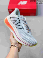 Angled side view of the New Balance RC Elite running shoe showing the logo, FuelCell-marked orange heel section, and lime outsole.