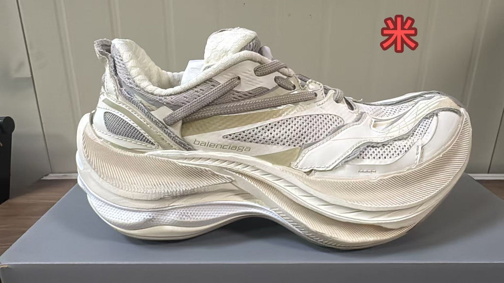 Cream Balenciaga sneaker with light mesh panels, tonal overlays, and a chunky textured sole.