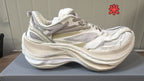 Cream Balenciaga sneaker with light mesh panels, tonal overlays, and a chunky textured sole.