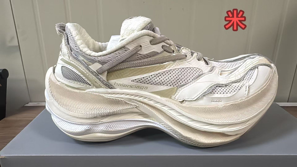 Cream Balenciaga sneaker with light mesh panels, tonal overlays, and a chunky textured sole.