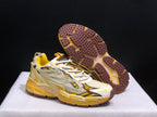 Three-quarter view showing the sneaker uppers and the brown outsole tread pattern.