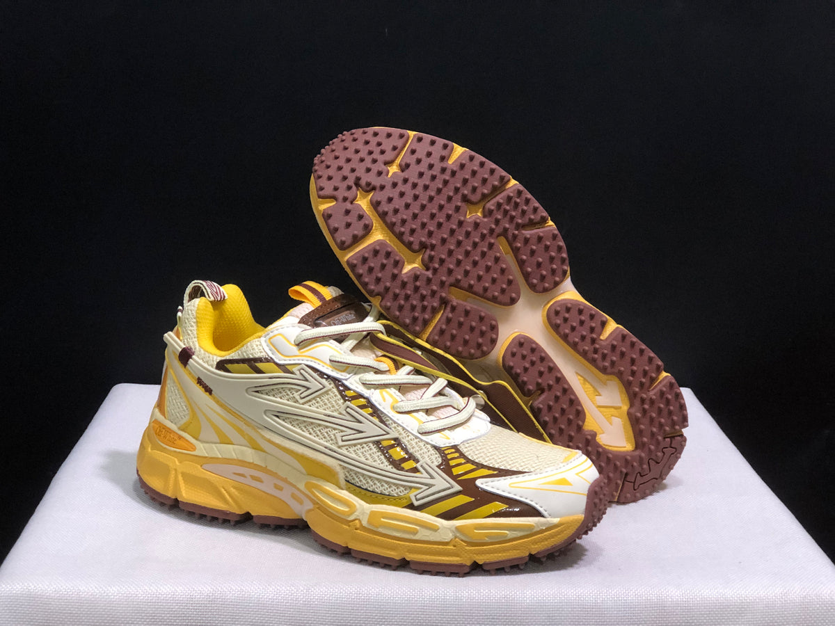 Three-quarter view showing the sneaker uppers and the brown outsole tread pattern.