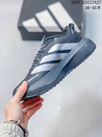 Side view of the sneaker highlighting the silver Adidas side stripes, mesh upper, and raised midsole.