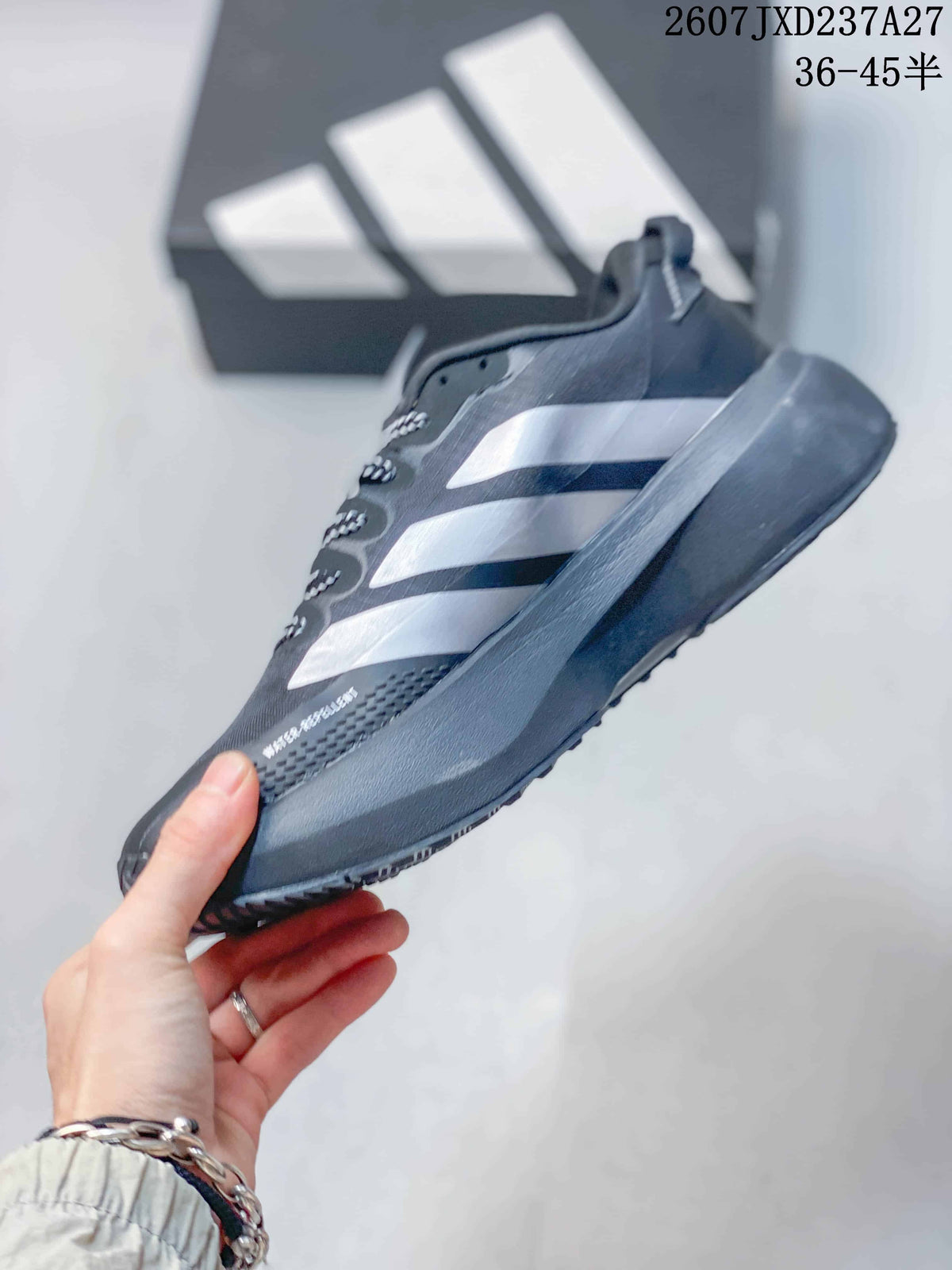 Side view of the sneaker highlighting the silver Adidas side stripes, mesh upper, and raised midsole.