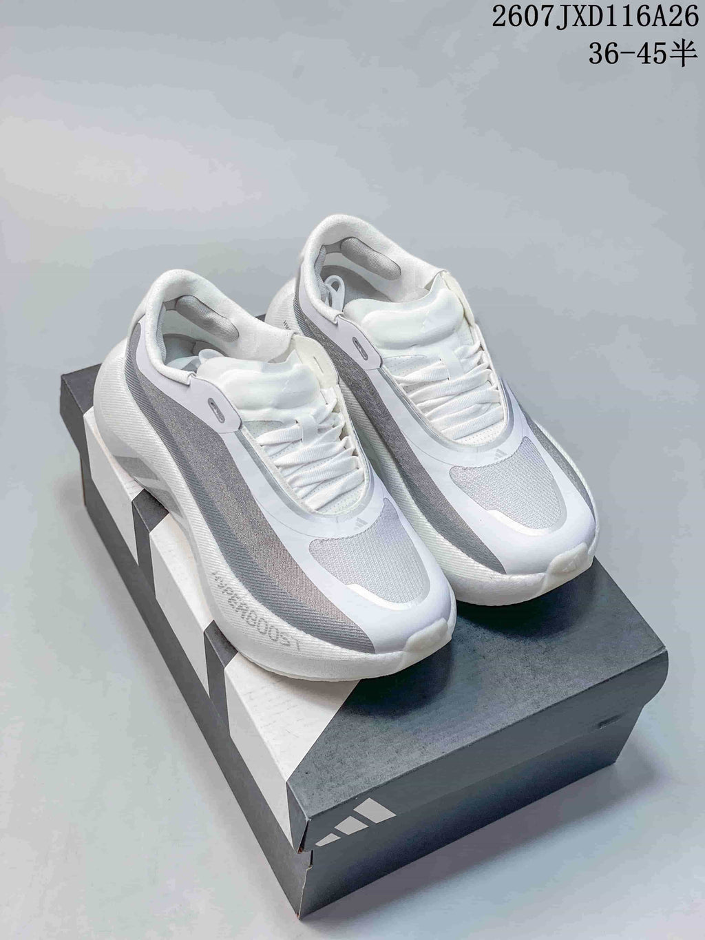 Pair of white and grey Adidas HYPERBOOST EDGE W sneakers displayed on an Adidas shoe box.