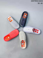Several Nike Mind 001 slides displayed together in white, black, red, and light neutral colorways.
