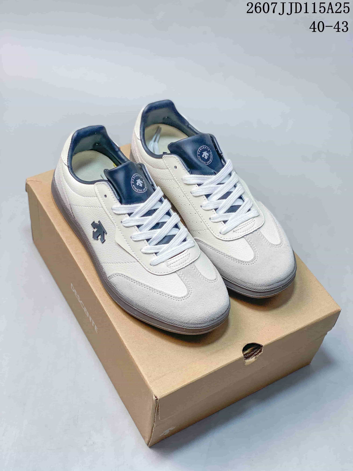 Pair of white and navy DESCENTE low-top sneakers displayed on a shoebox