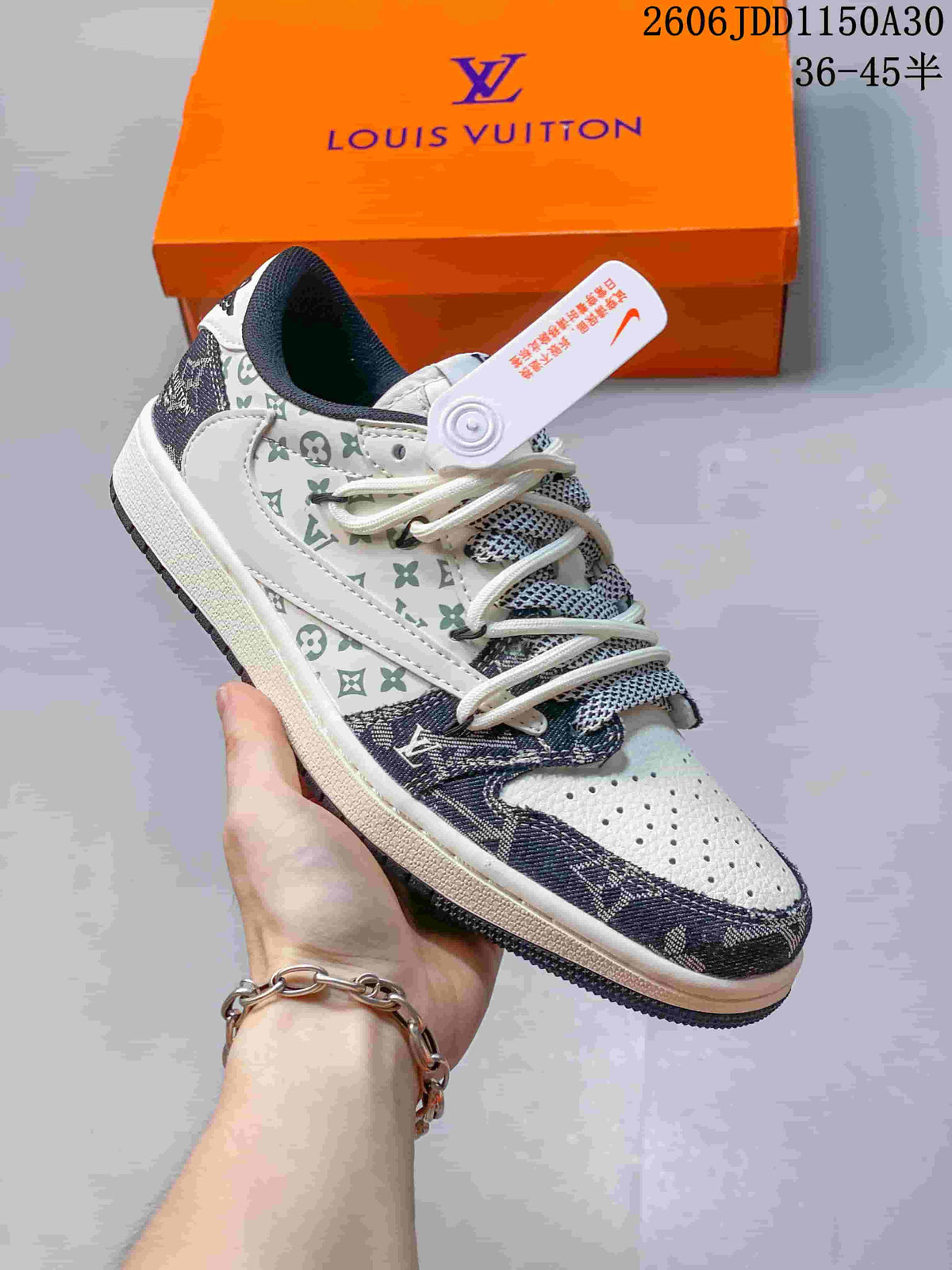 Angled side view of a low-top sneaker with monogram-style panels
