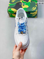 Top view showing the perforated toe box, blue patterned laces, padded collar, and metal lace hardware.