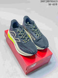 New Balance RC Elite running shoes shown from above on a red shoe box, with dark navy uppers, light midsoles and neon yellow accents.