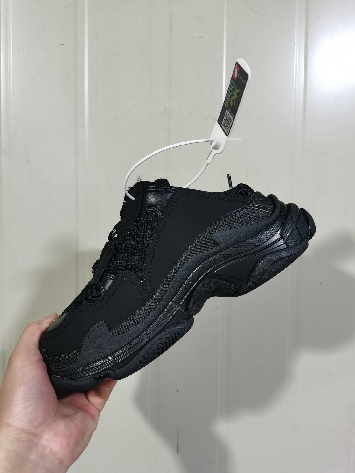 Rear three-quarter view of the black Balenciaga mule-style sneaker, showing the layered upper and sculpted outsole.