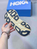 Close-up of the sneaker outsole showing segmented dark and cream traction areas.
