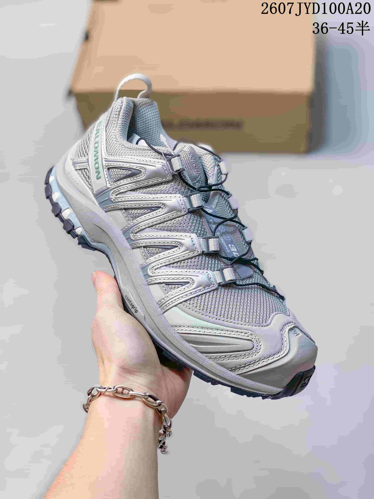 Angled side view of the grey Salomon XA PRO 3D shoe showing the upper overlays and outsole.