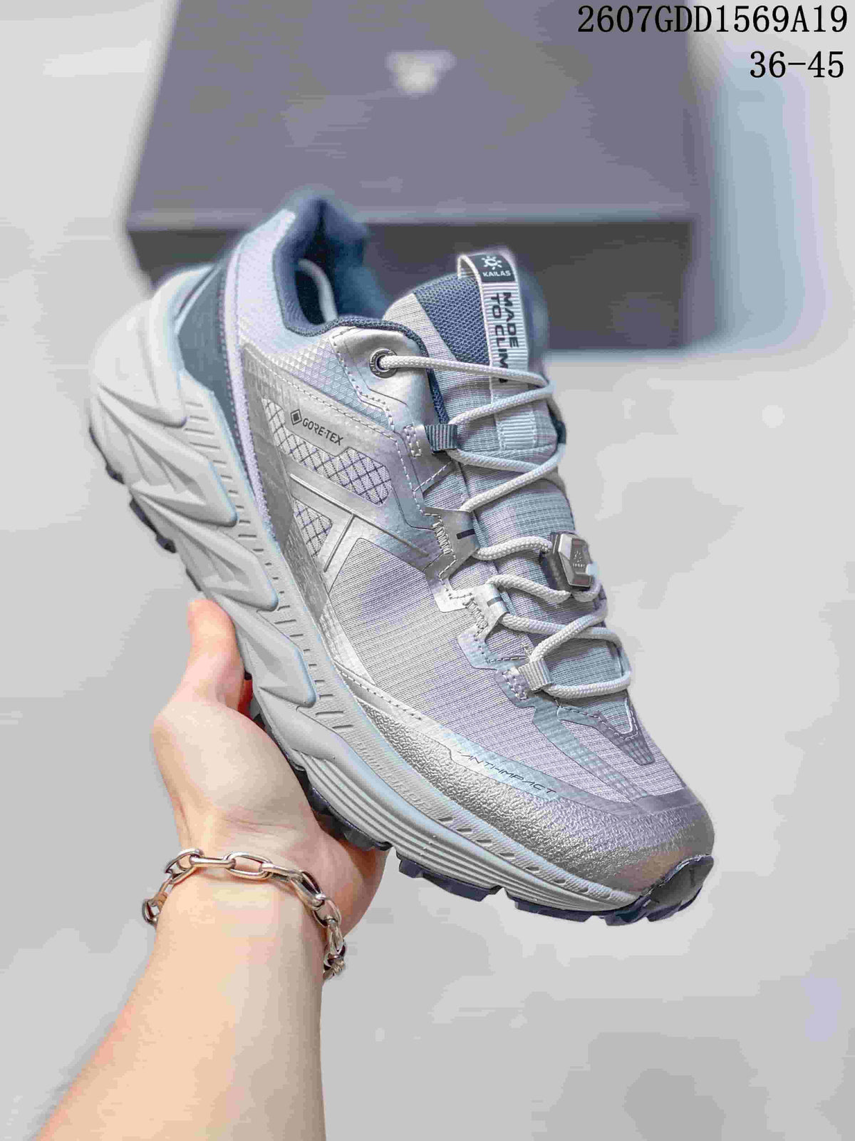 Close side view of a light gray KAILAS trail shoe with lavender-toned details and a visible GO-TE-TEX marking.