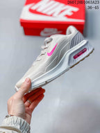 Side profile showing the bright pink Swoosh, sculpted midsole, and heel cushioning unit.