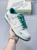 Angled side view showing the white and green colorway, Swoosh branding, and low-top silhouette.
