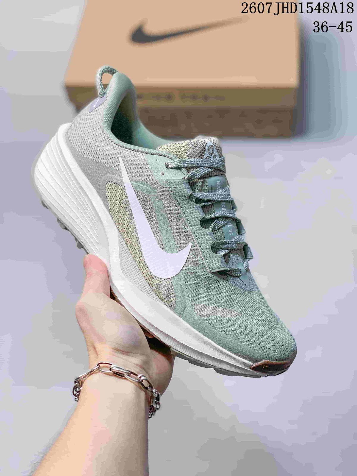Pale green and white Nike ReactX Pegasus ACG Trail 6 sneaker with a white Swoosh.
