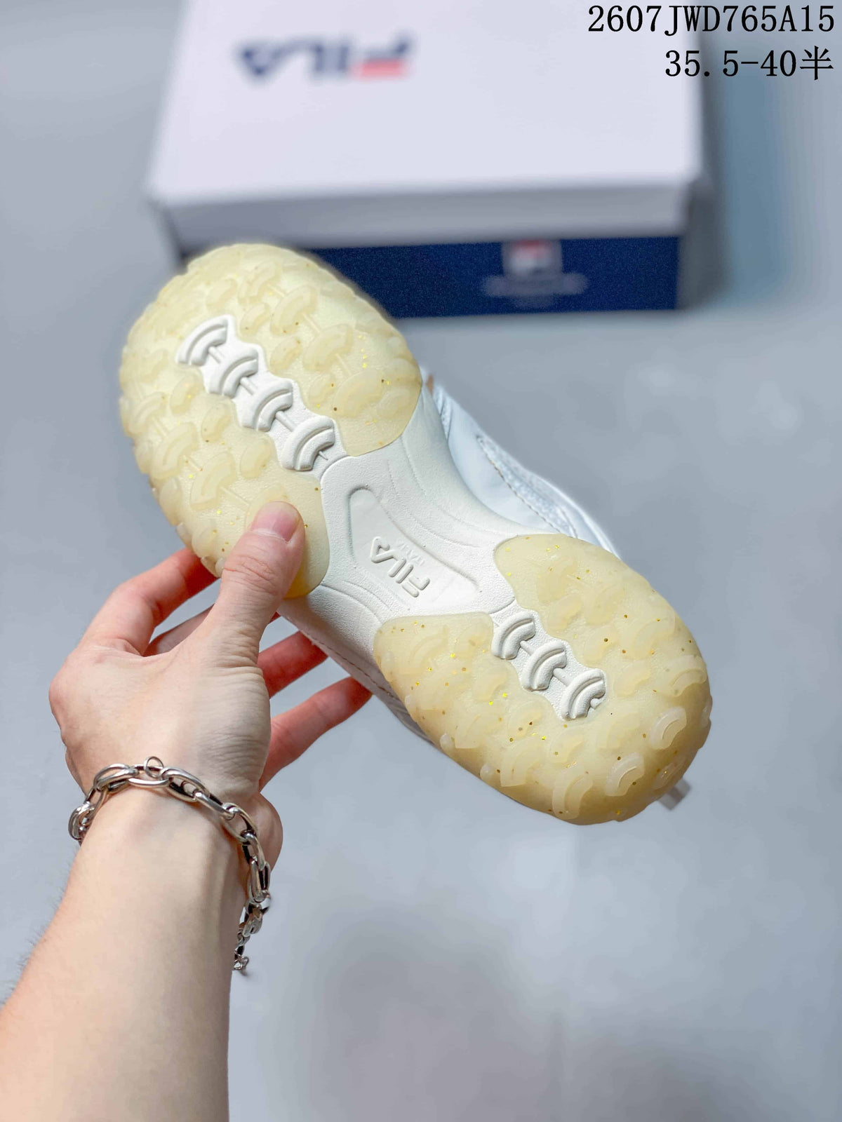 Underside view of a FILA sneaker showing the translucent textured outsole and tread pattern.