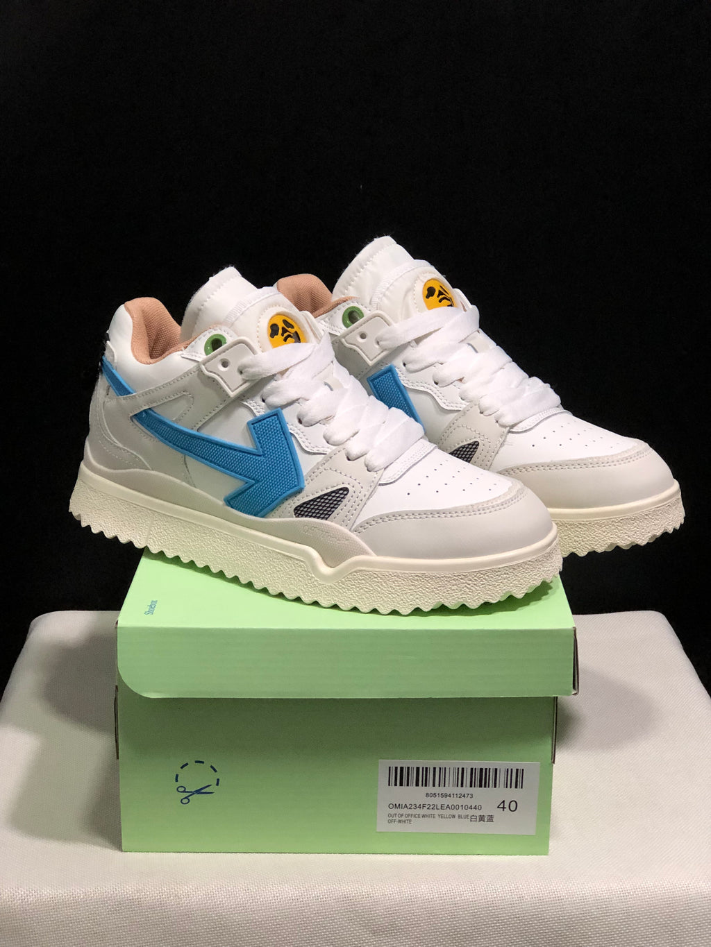 Pair of white and blue Off-White sneakers displayed on a green shoe box; the box label shows EU size 40.