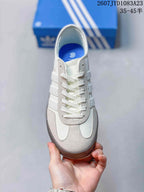 Top view of the sneaker showing white laces, gray overlays, and the rounded toe design.
